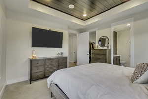 Bedroom with light colored carpet, a spacious closet, recessed lighting, a tray ceiling, and wooden ceiling