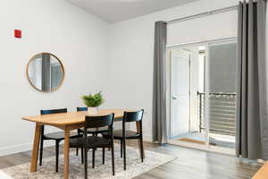 Dining area featuring light wood-style floors and baseboards