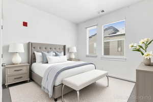 Bedroom #2 featuring baseboards and light carpet