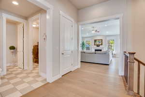 Hallway featuring recessed lighting, washer / dryer, and light wood finished floors