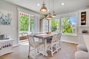 Dining room featuring light wood-type flooring, healthy amount of natural light, and recessed lighting