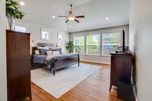 Bedroom with vaulted ceiling, light wood-style flooring, recessed lighting, and ceiling fan