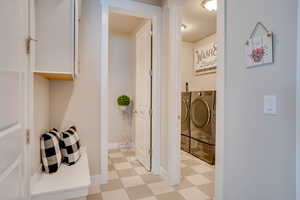 Laundry room featuring light floors and separate washer and dryer