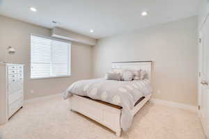 Bedroom with light carpet and recessed lighting