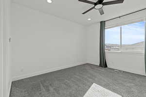 Primary bedroom featuring ceiling fan and recessed lighting