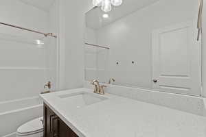 Bathroom with vanity and shower / tub combination