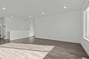 Unfurnished room with wood finished floors and recessed lighting