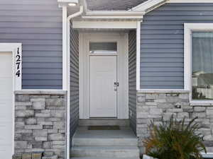 Doorway to property with stone siding.