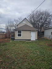 Rear view of house with a fenced backyard, a shingled roof, and a wooden deck