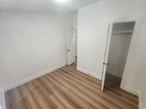 Unfurnished bedroom with a closet and wood finished floors