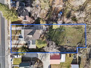 Aerial view of property and surrounding area featuring property parcel outlined