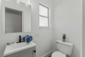 Half bathroom with vanity and toilet