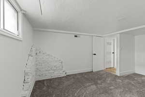 Unfurnished bedroom with carpet flooring and baseboards