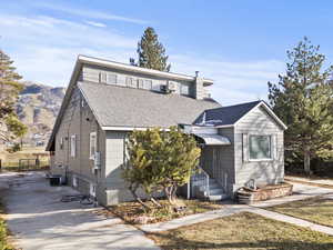 View of front of house with a shingled roof