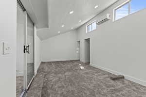 master bedroom with recessed lighting, a textured ceiling, dark carpet, and a wall mounted air conditioner