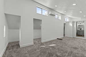 Upstairs master bedroom with carpet floors, a textured ceiling, and recessed lighting