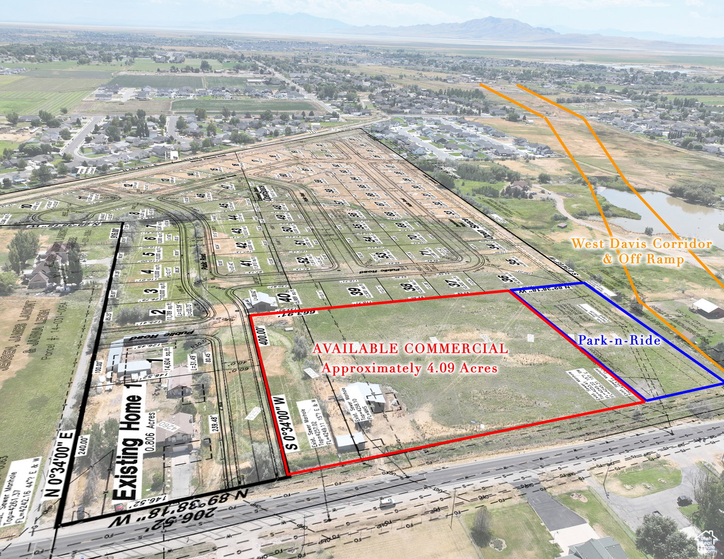 Aerial view of property and surrounding area featuring property boundaries highlighted and a mountain backdrop