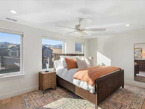Bedroom with recessed lighting, a ceiling fan, and light wood-style flooring