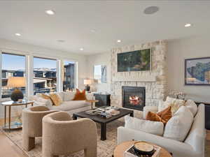 Living room featuring hardwood / wood-style flooring, a fireplace, and recessed lighting