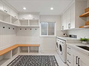 Laundry room with washer and dryer, recessed lighting, cabinet space, and light tile patterned floors