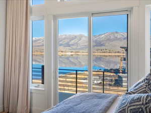 Bedroom featuring a water and mountain view and access to exterior