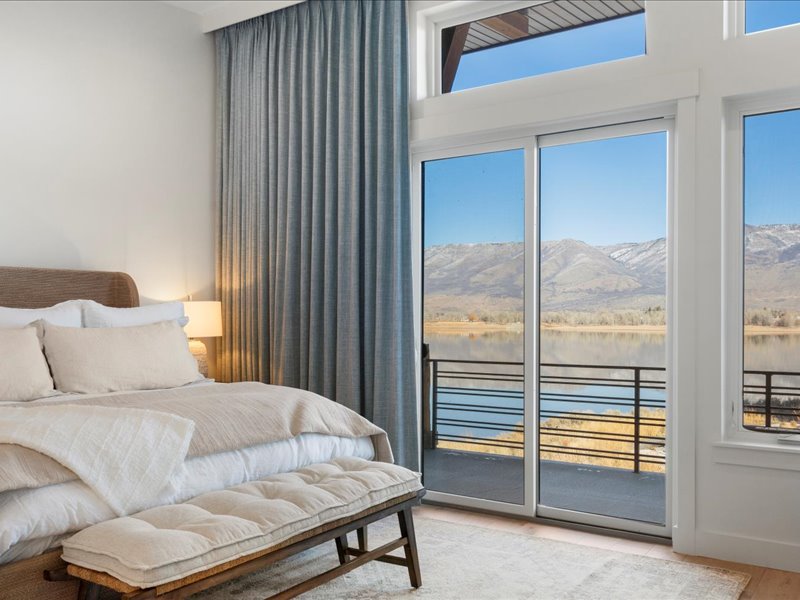 Bedroom with a water view and access to exterior