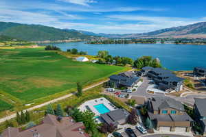 Drone / aerial view of a water and mountain view and a pool area