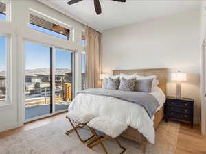 Bedroom with light wood finished floors, access to exterior, and a ceiling fan