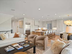 Living room with light wood finished floors and recessed lighting