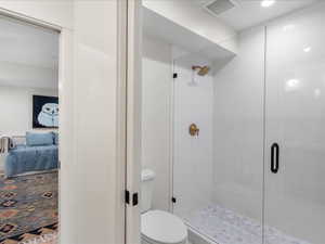 Ensuite bathroom featuring a shower stall and recessed lighting