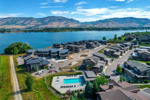 Bird's eye view of a water and mountain view and a pool