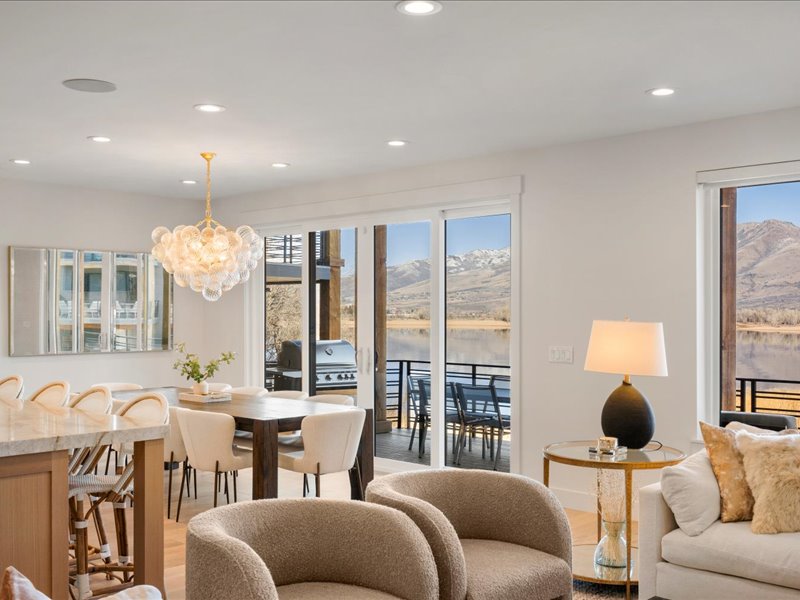 Living area featuring a chandelier, recessed lighting, healthy amount of natural light, light wood-style flooring, and a water and mountain view