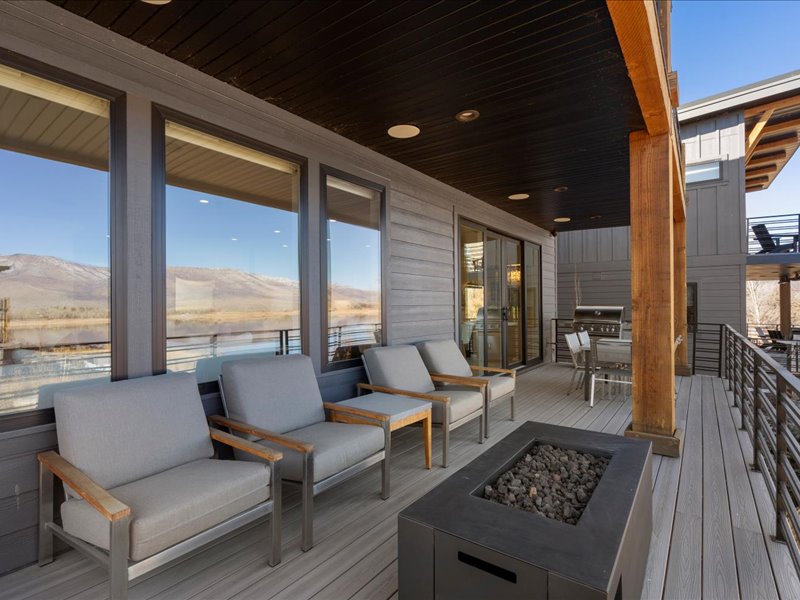 Deck with a fire pit, outdoor dining space, and grilling area