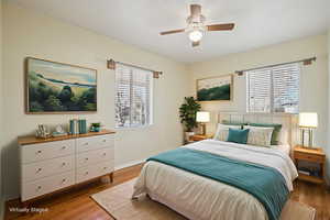 Bedroom featuring wood finished floors and a ceiling fan