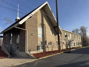 View of property exterior with brick siding and stairs