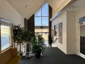 Sitting room featuring high vaulted ceiling