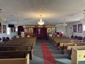 Misc room with plenty of natural light, a chandelier, and a textured ceiling