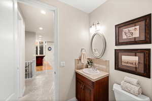 Bathroom with vanity, recessed lighting, and decorative backsplash