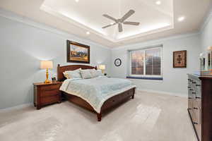 Bedroom featuring ornamental molding, carpet, ceiling fan, a raised ceiling, and recessed lighting