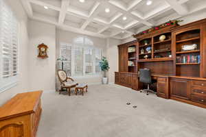 Home office with built in desk, coffered ceiling, light carpet, beamed ceiling, and recessed lighting