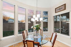 Dining space with a chandelier and light wood-type flooring