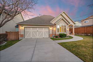 Ranch-style house with a shingled roof, concrete driveway, stucco siding, and an attached garage