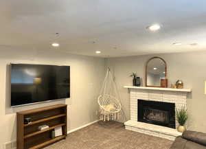 Living area with carpet floors, a fireplace, and recessed lighting