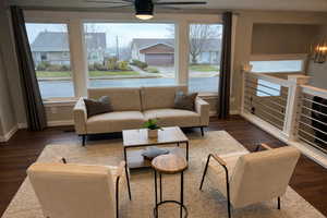 Living room with dark wood-type flooring and a residential view