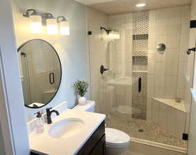 Bathroom featuring vanity and a stall shower