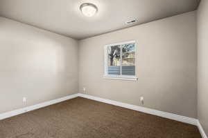Bedroom featuring baseboards and carpet