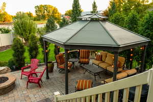 Summer view of patio / terrace with an outdoor living space with a fire pit and a gazebo