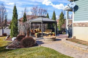 View of patio / terrace featuring a gazebo and a fire pit