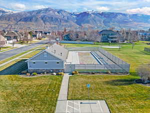 Aerial perspective of pool house / pool area and open space featuring a mountain backdrop