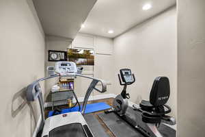 Workout room featuring recessed lighting